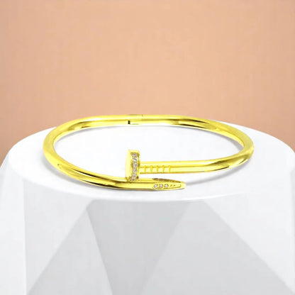 Bracelet on geometric prop with peach color gradient in the background