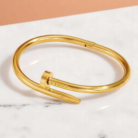 Bracelet on geometric prop with peach color gradient in the background