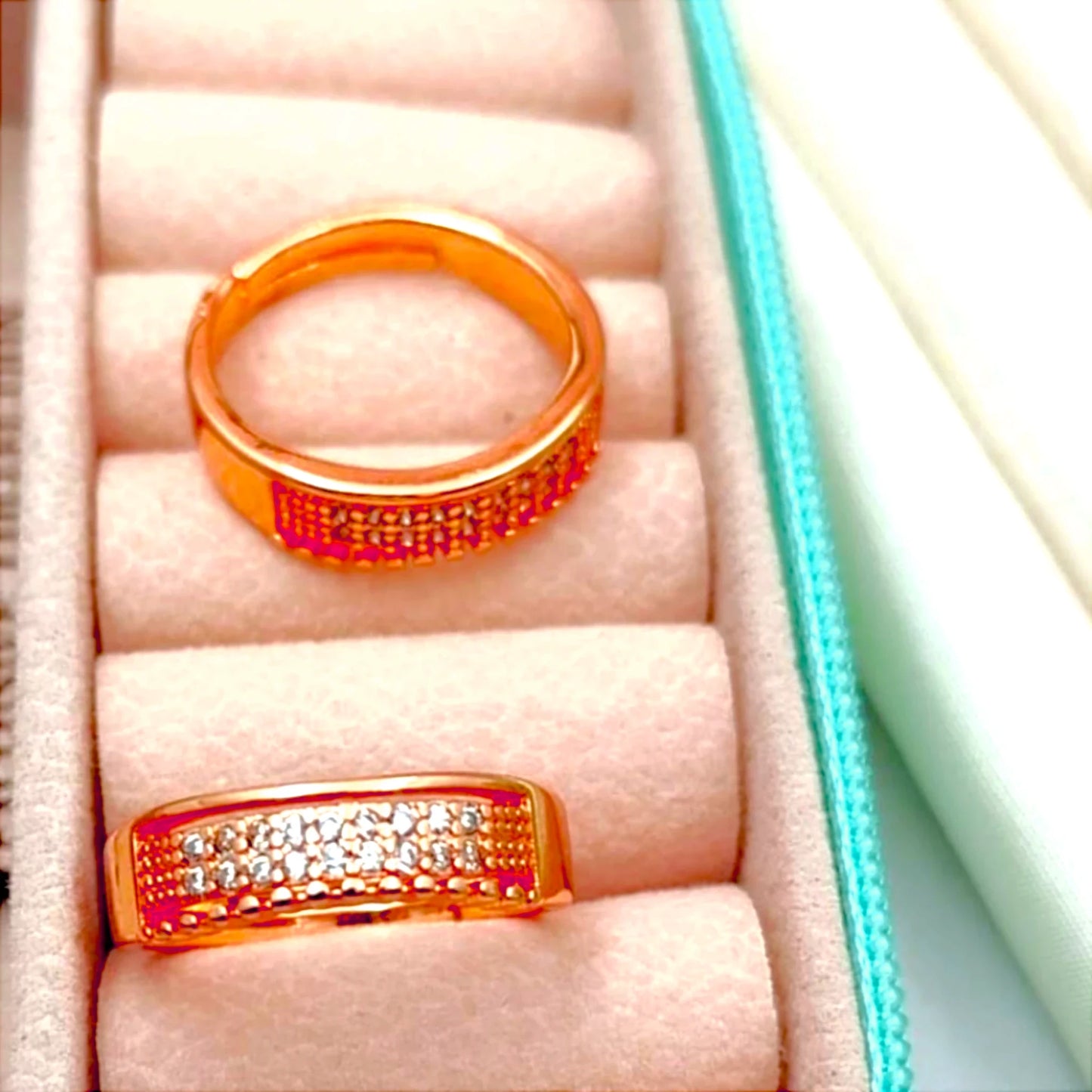 Two rings displayed in a velvet jewelry box.