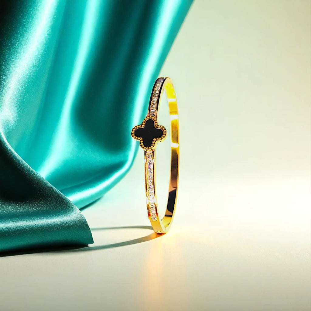 Bracelet set against a soft teal cloth background.