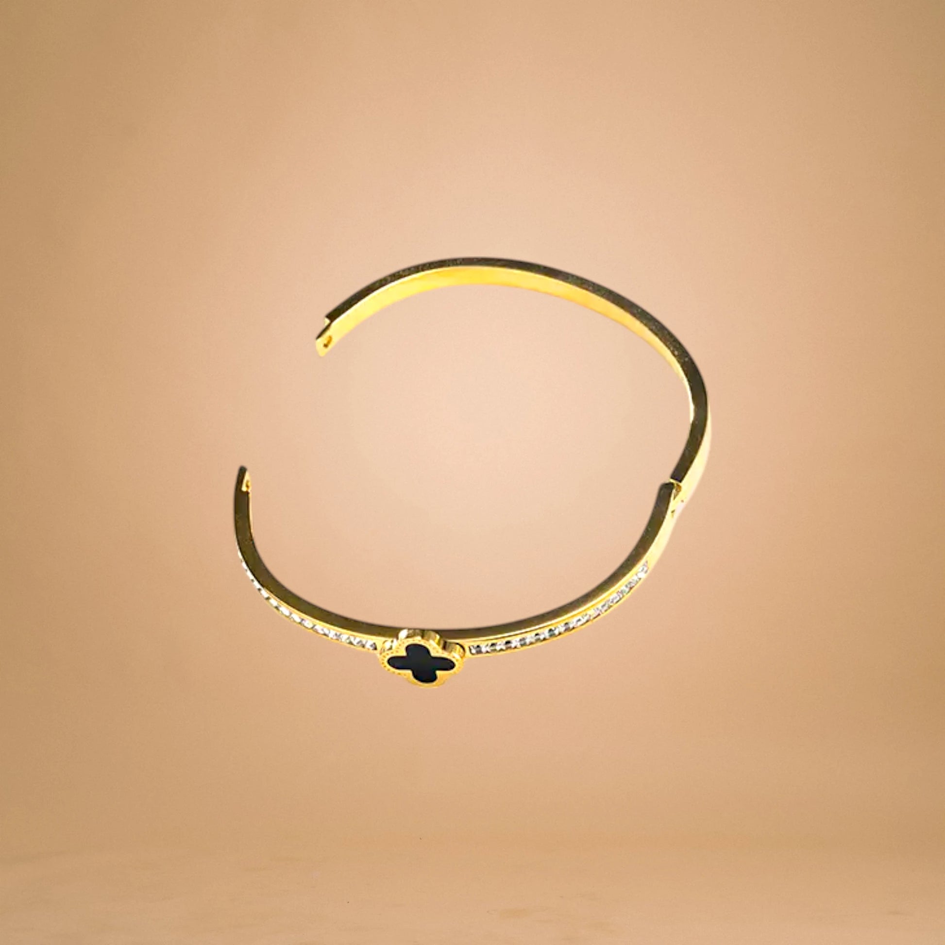 Bracelet on geometric prop with peach color gradient in the background.