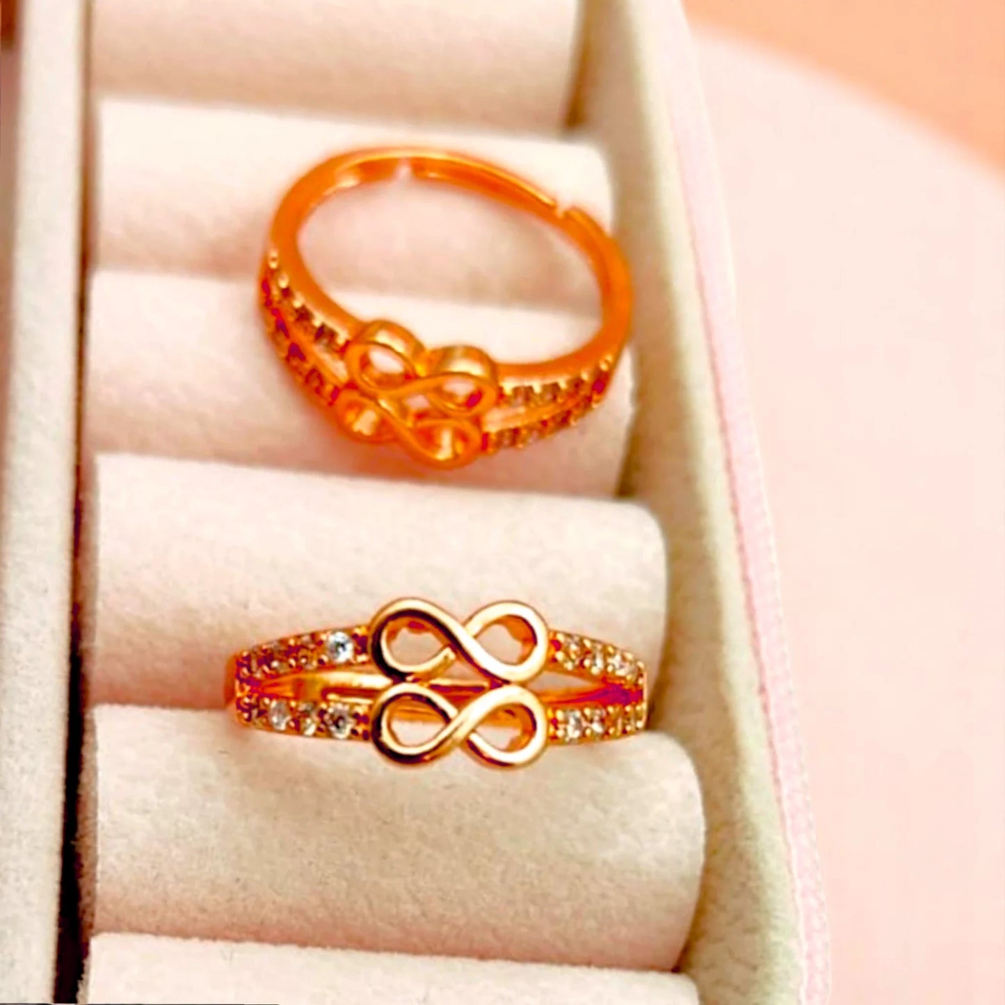 Two rings displayed in a velvet jewelry box.