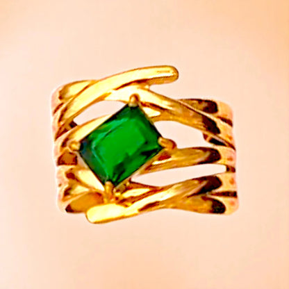 Ring on a color gradient of a peach-toned background.