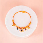 Bracelet on geometric prop with peach color gradient in the background.