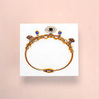 Bracelet on geometric prop with peach color gradient in the background.