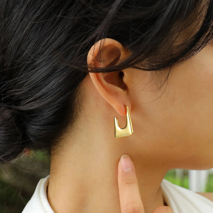 Geo Cutout Stud Earrings worn by a model.