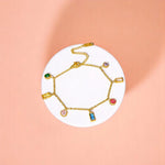 Bracelet on geometric prop with peach color gradient in the background.