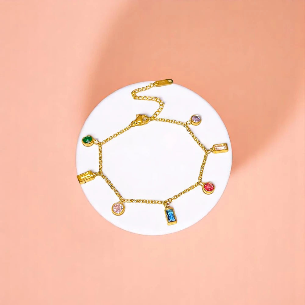 Bracelet on geometric prop with peach color gradient in the background.