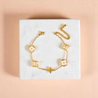 Bracelet on geometric prop with peach color gradient in the background.