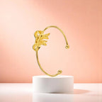 Bracelet on geometric prop with peach color gradient in the background.