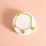 Bracelet on geometric prop with peach color gradient in the background.