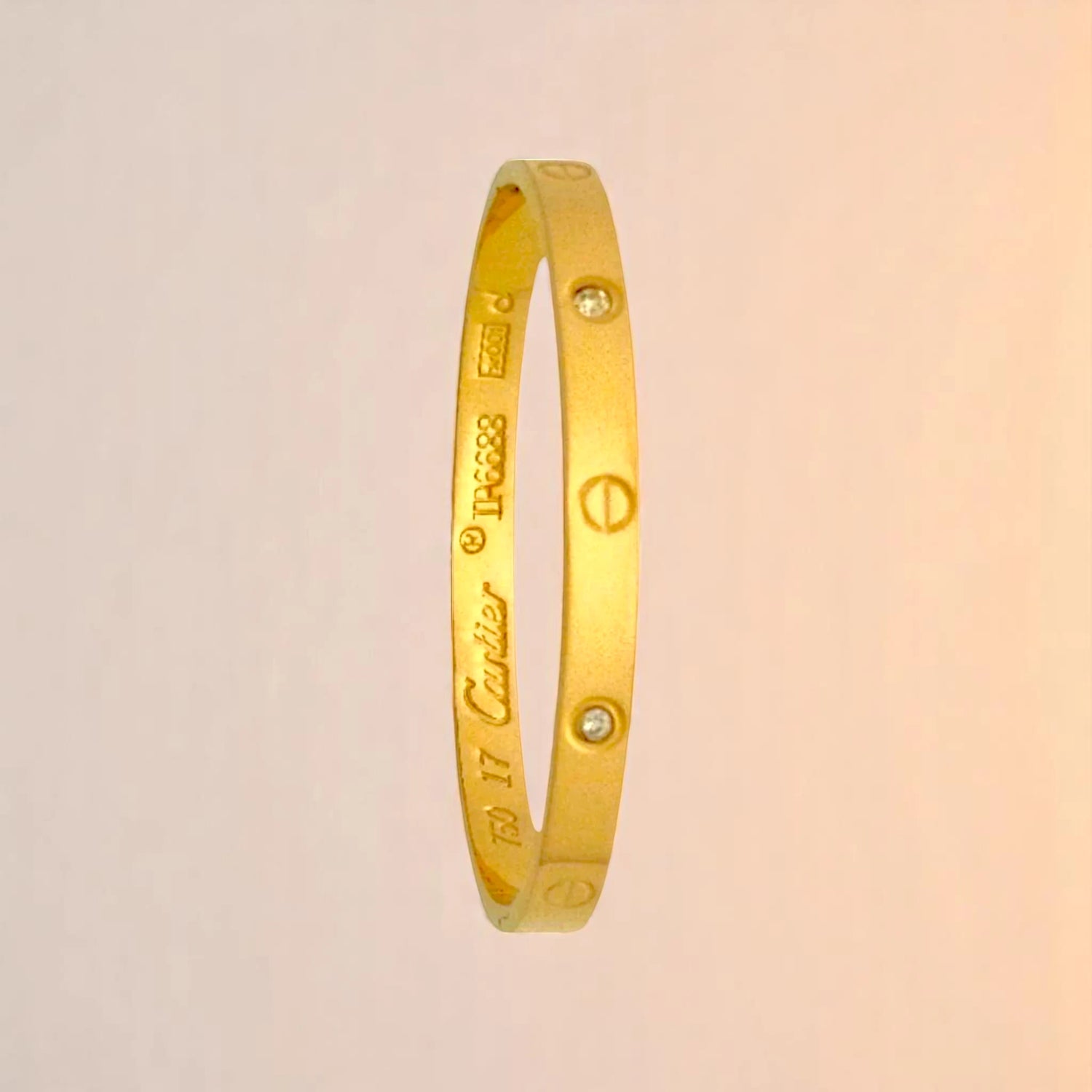 Bracelet on a color gradient of peach tones background.