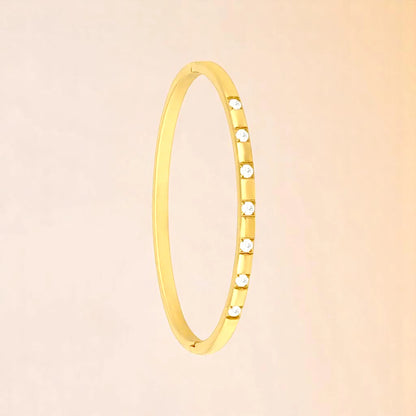 Bracelet on a color gradient of peach tones background.