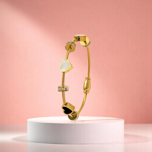 Bracelet on geometric prop with peach color gradient in the background.