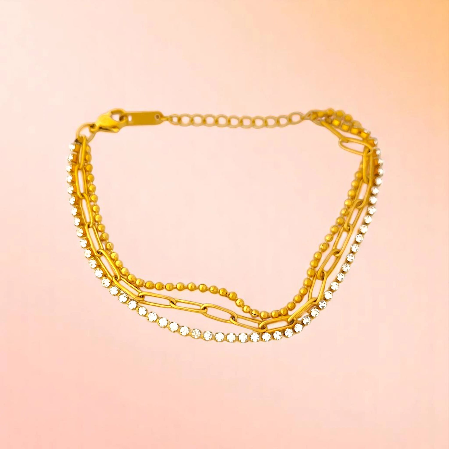 Bracelet on a color gradient of peach tones background.