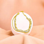 Bracelet on geometric prop with peach color gradient in the background.