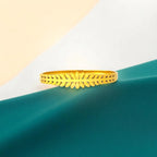 Bracelet set against a soft teal cloth background.