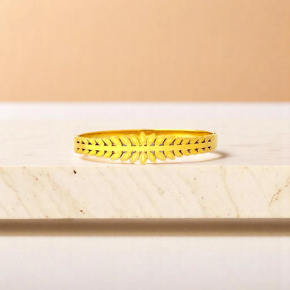Bracelet on geometric prop with peach color gradient in the background.