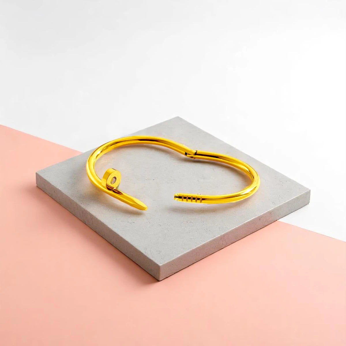 Bracelet displayed on a light-colored travertine stone slab with a peach-colored gradient in the background.