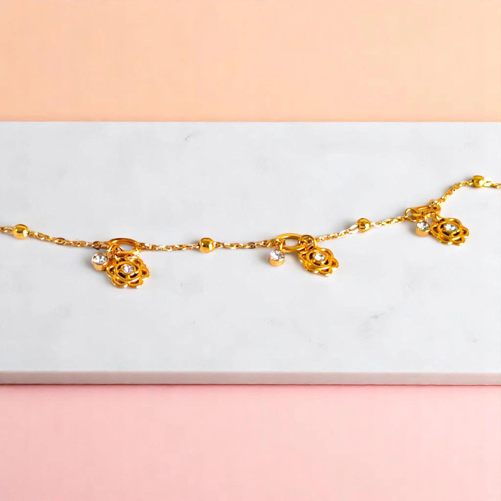 Bracelet on geometric prop with peach color gradient in the background.