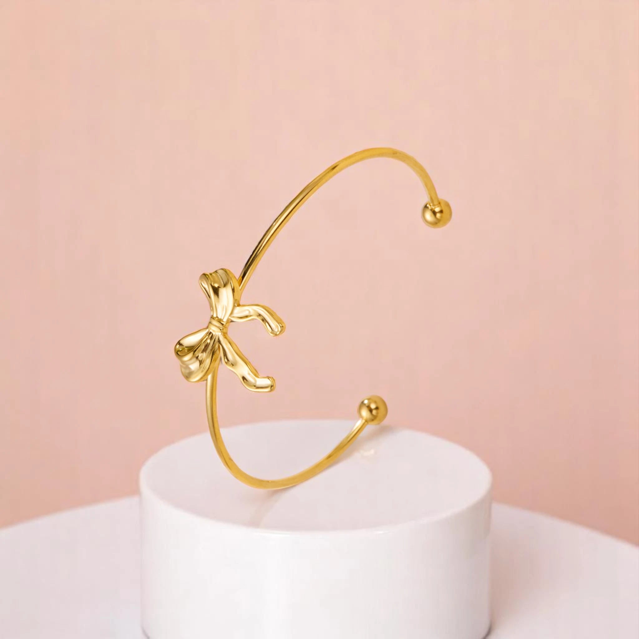 Bracelet on geometric prop with peach color gradient in the background.