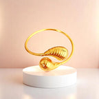 Bracelet on geometric prop with peach color gradient in the background.