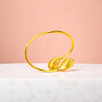 Bracelet on geometric prop with peach color gradient in the background.