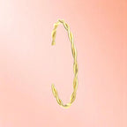 Bracelet on a color gradient of peach tones background.