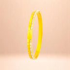 Bracelet on a color gradient of peach tones background.