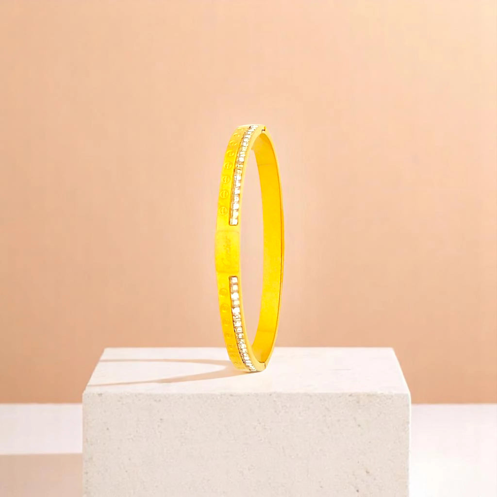 Bracelet on geometric prop with peach color gradient in the background.