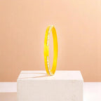 Bracelet on geometric prop with peach color gradient in the background.