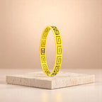 Bracelet on geometric prop with peach color gradient in the background.