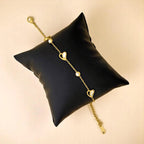 Bracelet rests elegantly on a black pillow against a neutral background.