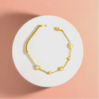 Bracelet on geometric prop with peach color gradient in the background.