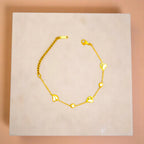 Bracelet on geometric prop with peach color gradient in the background.