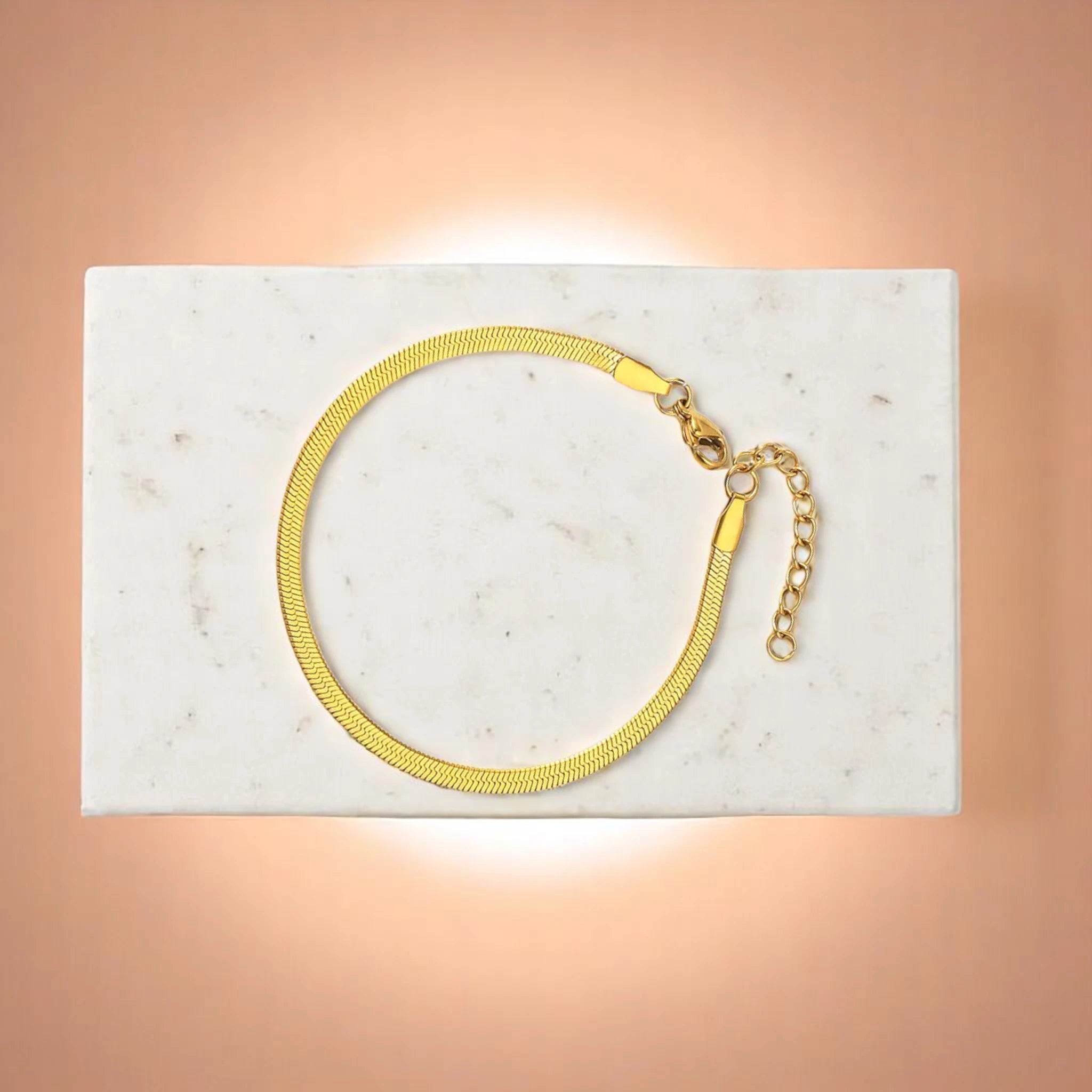 Bracelet on geometric prop with peach color gradient in the background.