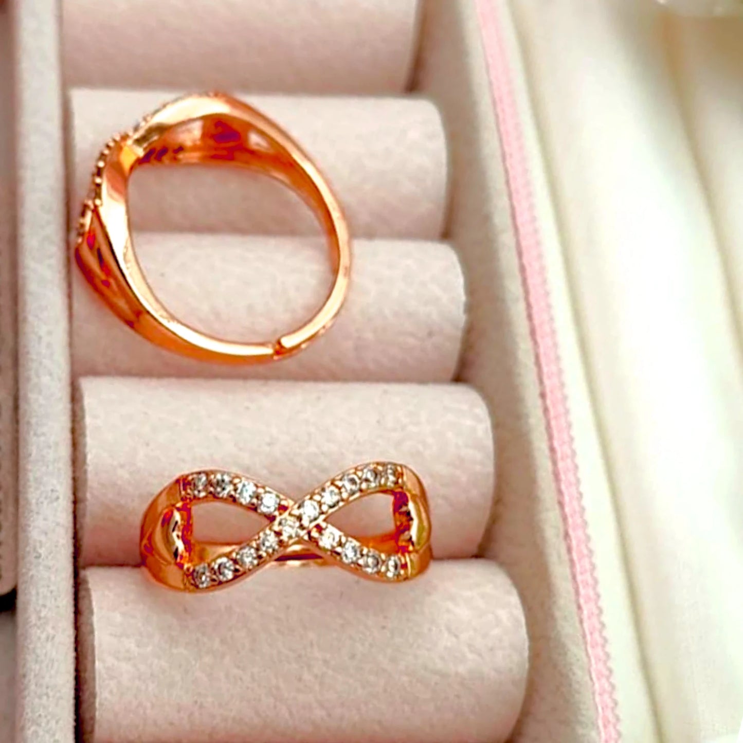 Two rings displayed in a velvet jewelry box.
