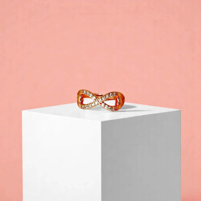 Ring on a white cube geometric prop with a peach color gradient in the background.