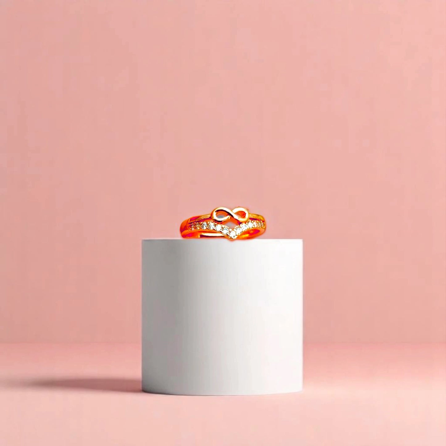 Ring on a white cylindrical geometric prop with a peach color gradient in the background.