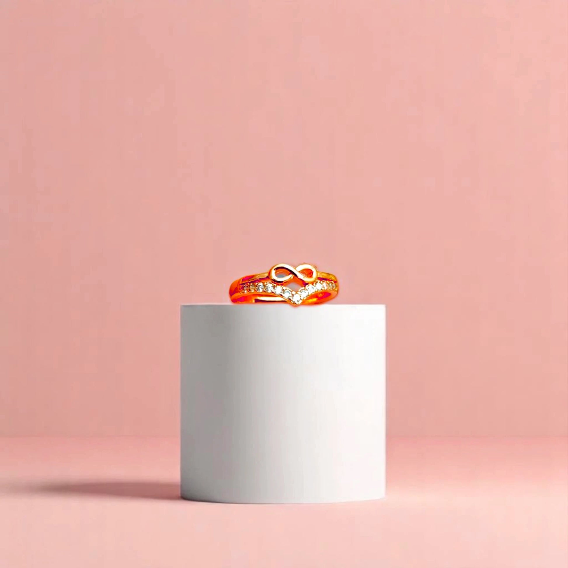 Ring on a white cylindrical geometric prop with a peach color gradient in the background.
