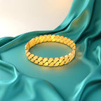 Bracelet set against a soft teal cloth background.