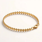 Gold teardrop chain bracelet side angle on acrylic riser, depth and clasp.