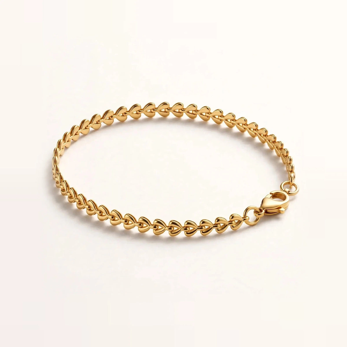 Gold teardrop chain bracelet side angle on acrylic riser, depth and clasp.