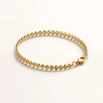 Gold teardrop chain bracelet side angle on acrylic riser, depth and clasp.