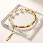 Side angle view of gold bamboo pearl bracelet with gold S.STEEL extension from pearl side