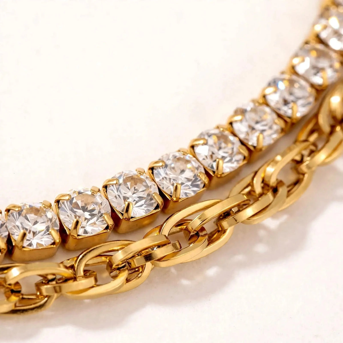Extreme macro close-up of gold double-layer bracelet with cubic zirconia and cable chain