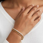 Indian woman in white sweater wearing gold double-layer bracelet with cubic zirconia