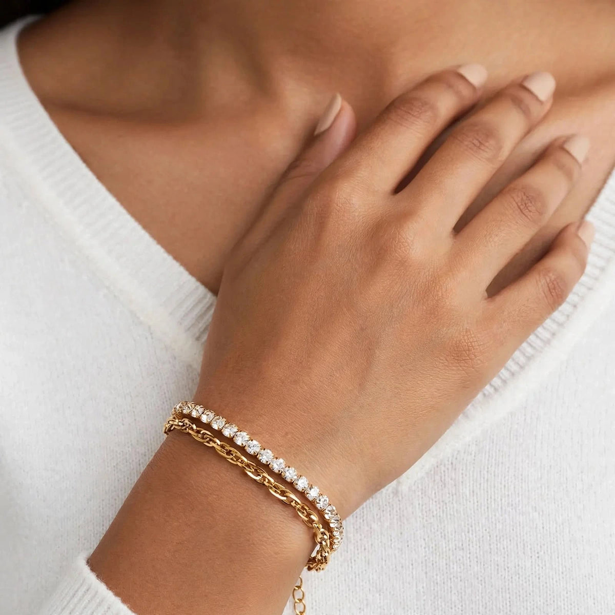 Indian woman in white sweater wearing gold double-layer bracelet with cubic zirconia