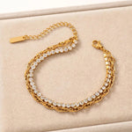 Gold double-layer bracelet with cubic zirconia on beige velvet tray