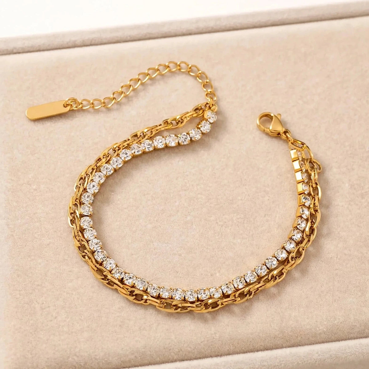 Gold double-layer bracelet with cubic zirconia on beige velvet tray